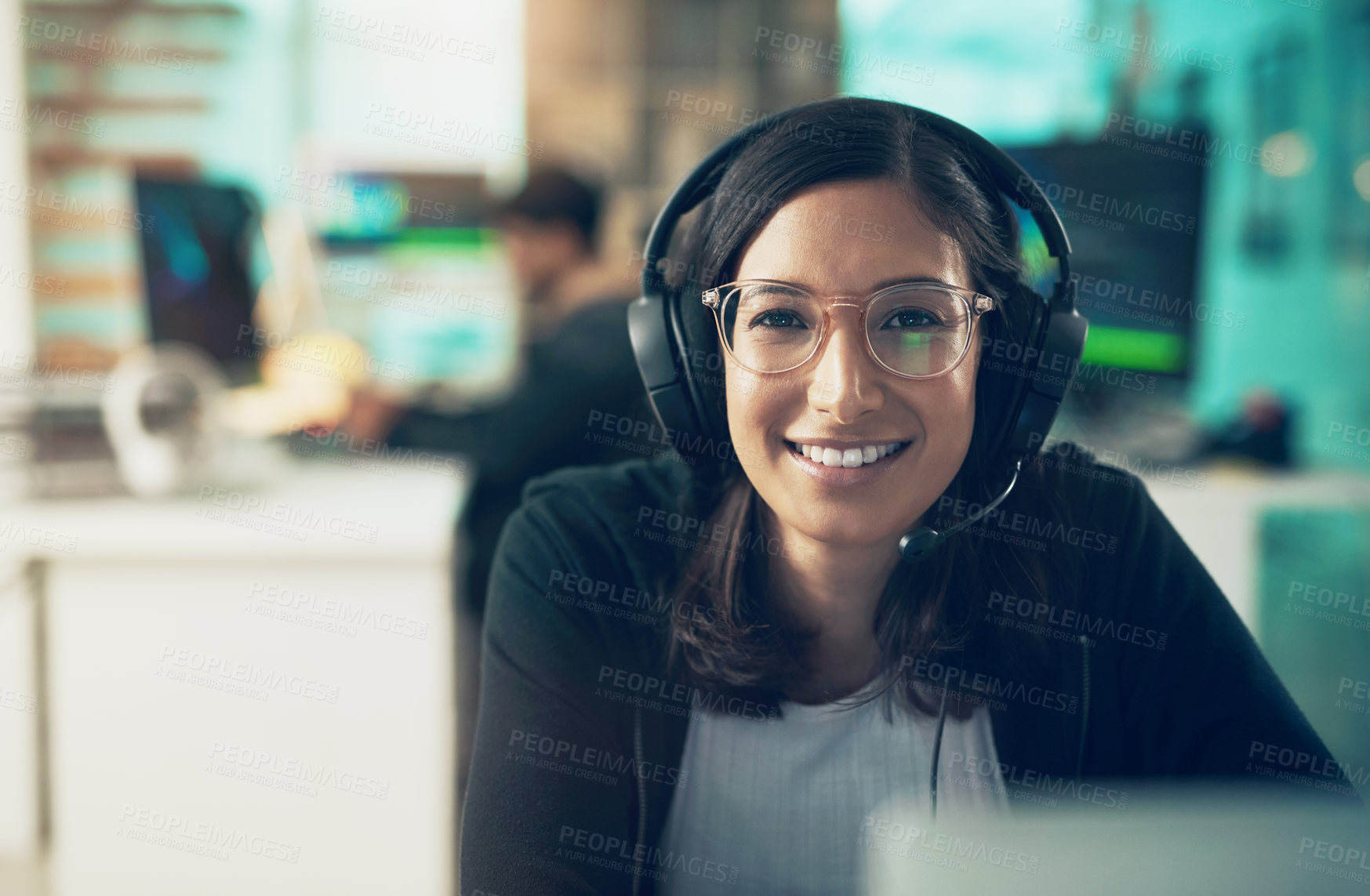 Buy stock photo Portrait of a young woman using a headset in a modern office