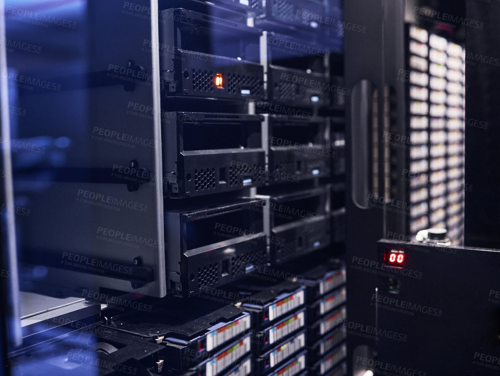 Buy stock photo Cropped shot of a large, dark and empty server room