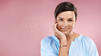 Buy stock photo Cropped portrait of an attractive young woman posing in studio against a pink background