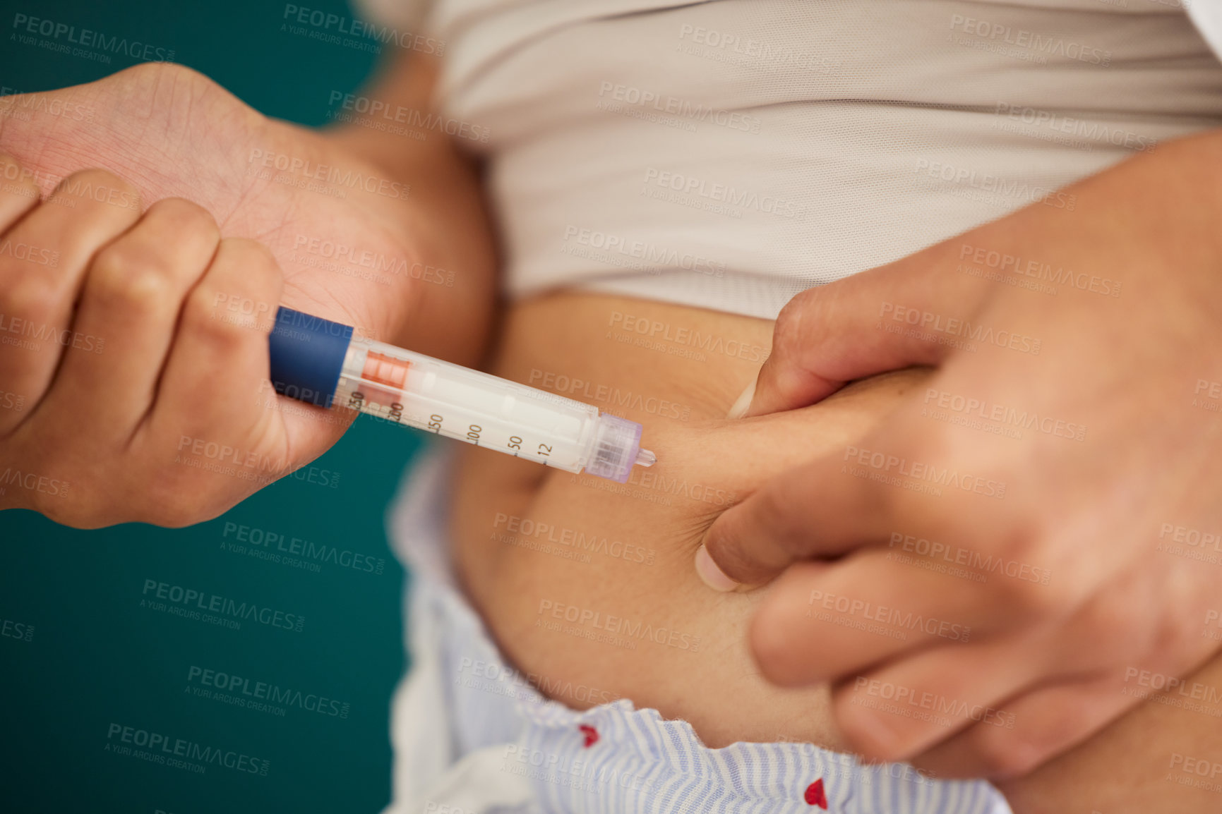 Buy stock photo Closeup shot of an unrecognizable woman injecting herself in the stomach with insulin at home