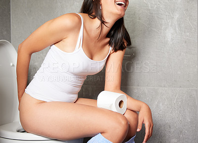 Buy stock photo Shot of a young woman using the toilet at home