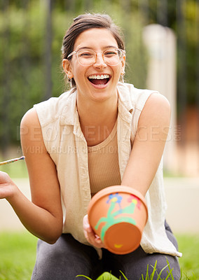 Buy stock photo Clay, pot and portrait of woman painting a craft container for plant in garden with creativity in hobby. Ceramic, art and artist with inspiration outdoor with paint brush, decoration or fun project