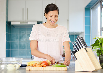 Buy stock photo Shot of a woman chopping up celery