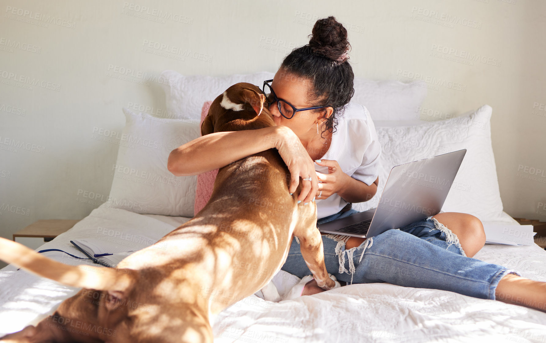 Buy stock photo Shot of a beautiful young woman using a laptop while relaxing with her dog in bed at home