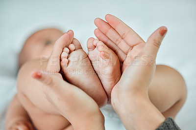 Buy stock photo Closeup shot of a woman holding up her baby's tiny feet