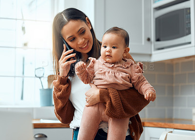 Buy stock photo Cropped shot of an attractive young woman carrying her newborn baby while working at home
