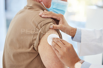 Buy stock photo Cropped shot of an unrecognizable doctor preparing her patient for a Covid vaccine in her clinic