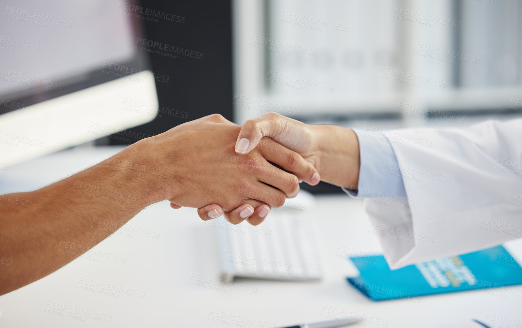Buy stock photo Cropped shot of an unrecognizable doctor shaking hands with her patient during a consult in the clinic