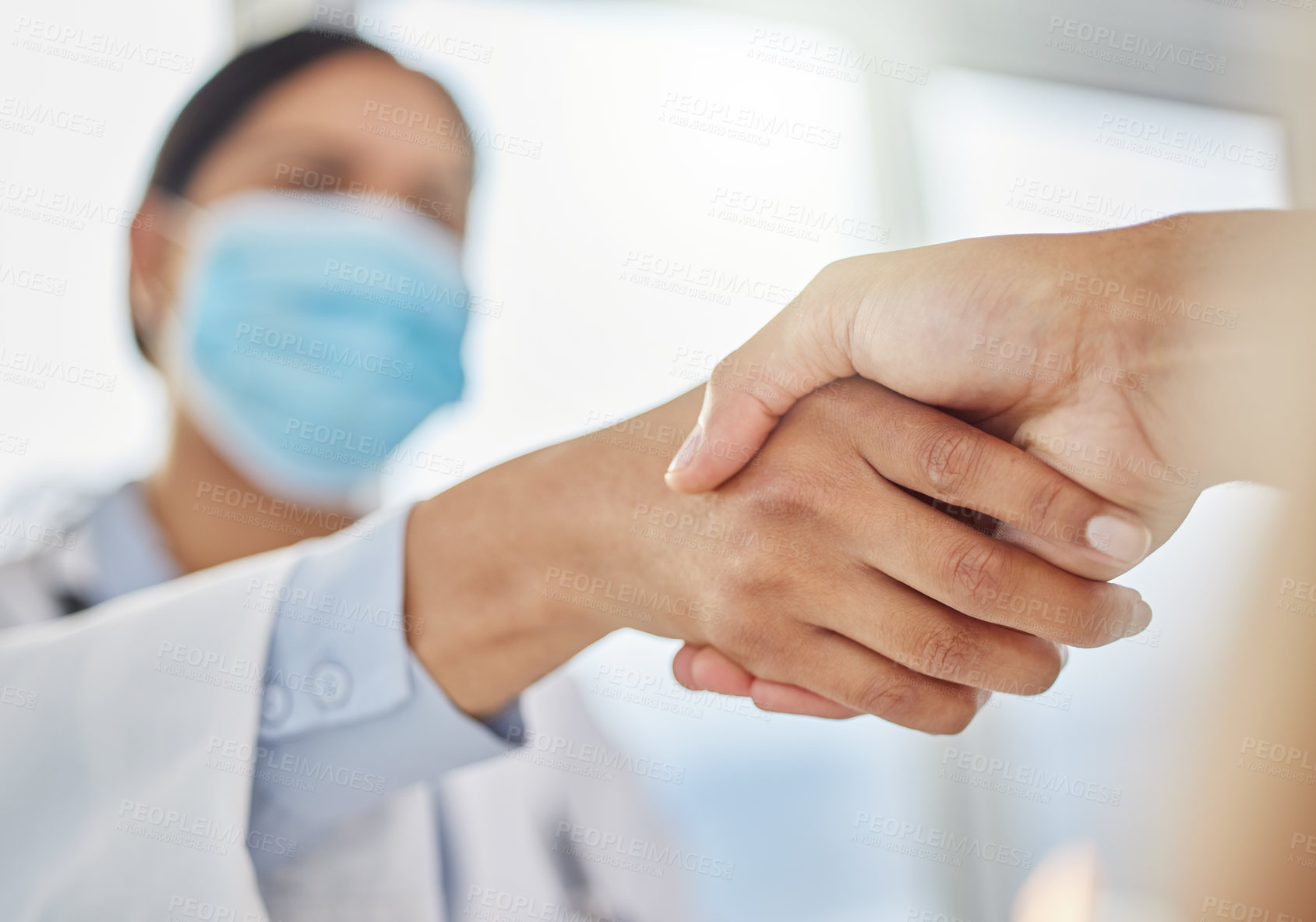Buy stock photo Shot of an unrecognizable doctor shaking hands with her patient during a consult in the clinic
