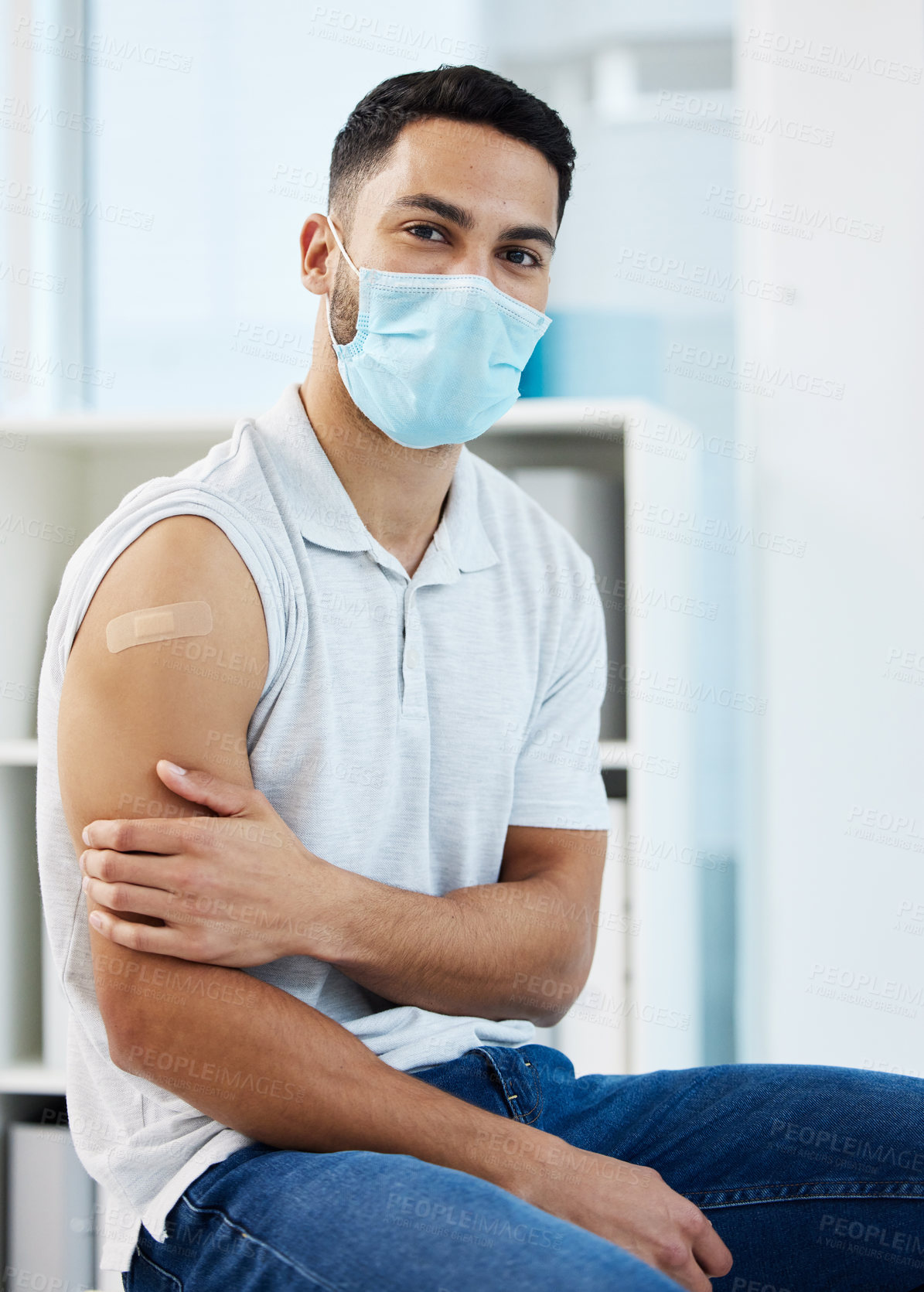 Buy stock photo Healthcare, portrait and a man with covid vaccine, virus safety and protection from a clinic. Arm plaster, medicine and a person with a face mask while sick with corona and getting a vaccination