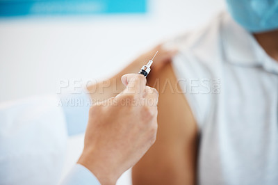 Buy stock photo Cropped shot of an unrecognizable doctor injecting her patient with the Covid vaccine in her clinic