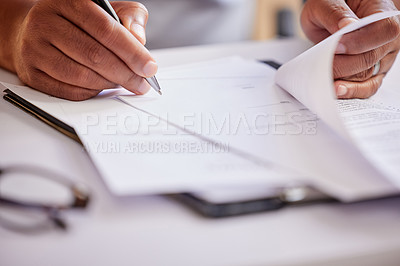 Buy stock photo Cropped shot of an unrecognizable businessman filling out paperwork while sitting in his office