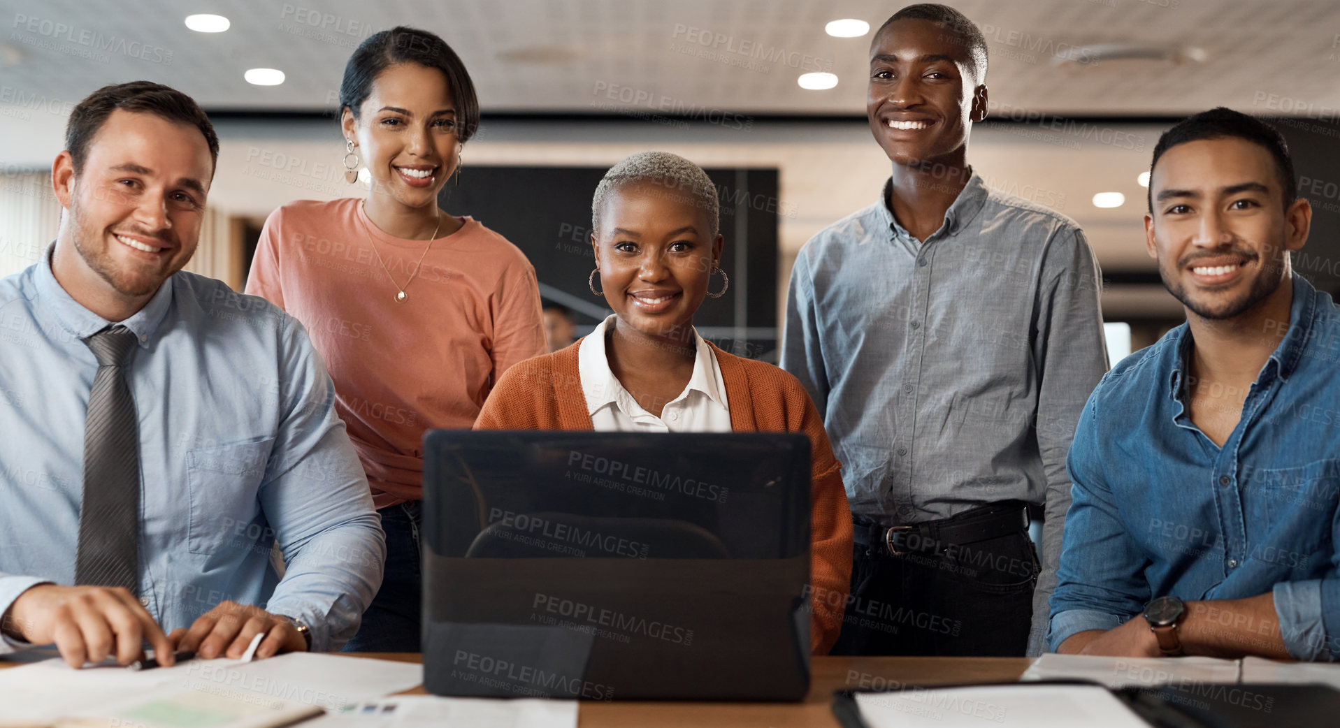 Buy stock photo Shot of a group of young businesspeople using a laptop at a conference in a modern office