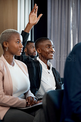 Buy stock photo Shot of a young businessman raising his hand during a conference in a modern office