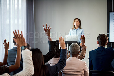 Buy stock photo Rearview shot of a group of businesspeople raising their hands during a conference