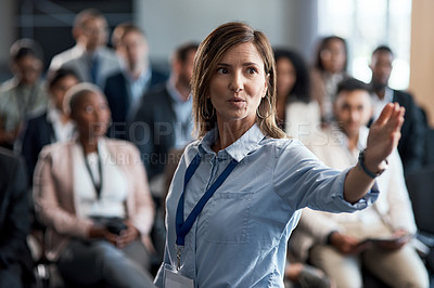 Buy stock photo Shot of a businesswoman delivering a presentation at a conference