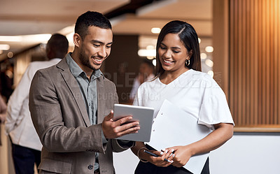 Buy stock photo Shot of a young businessman and businesswoman using a digital tablet at a conference