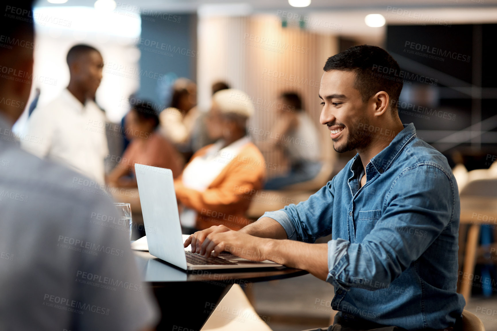 Buy stock photo Shot of a young businessman using a laptop at a conference