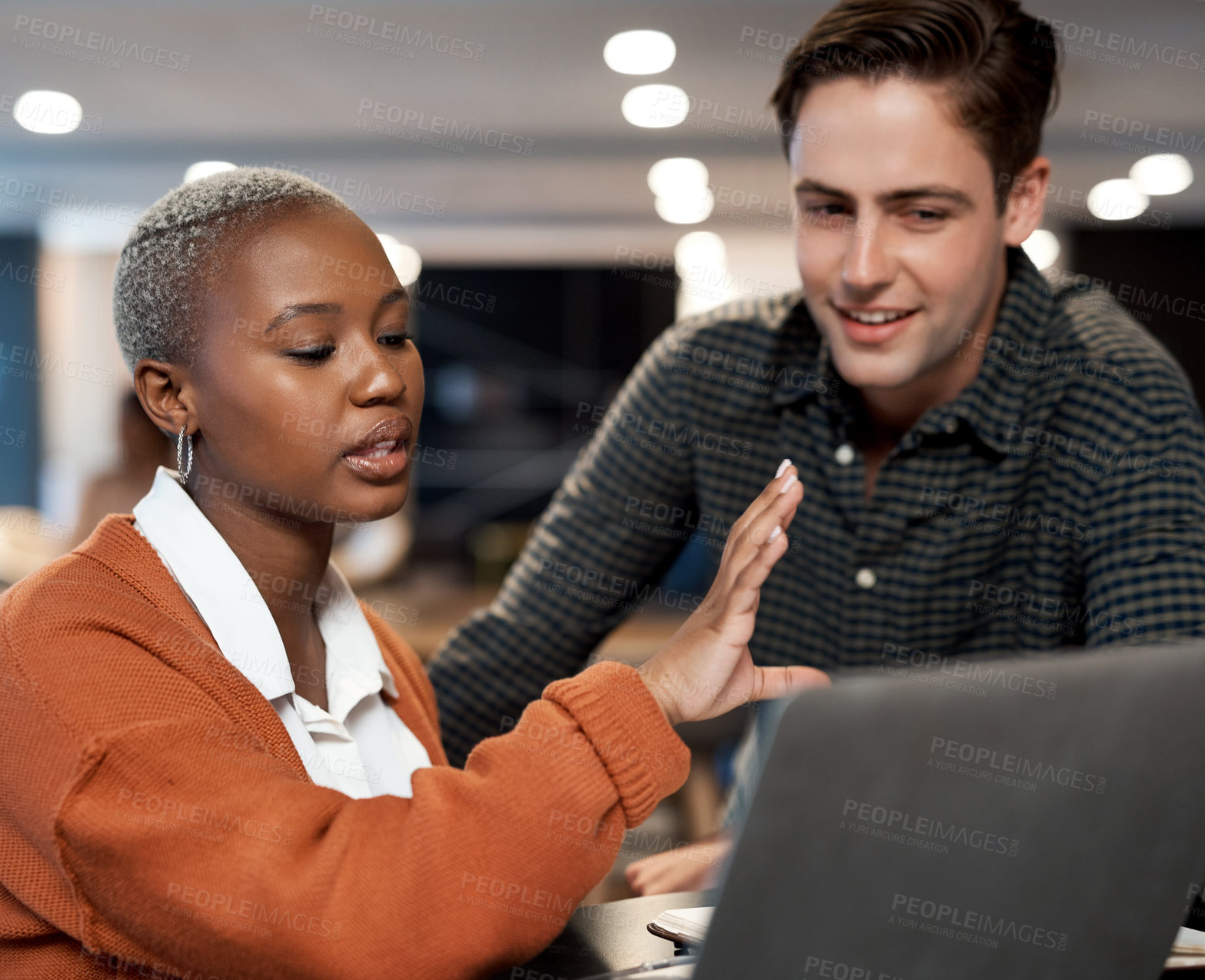 Buy stock photo Shot of a young businessman and businesswoman using a laptop during a conference in a modern office