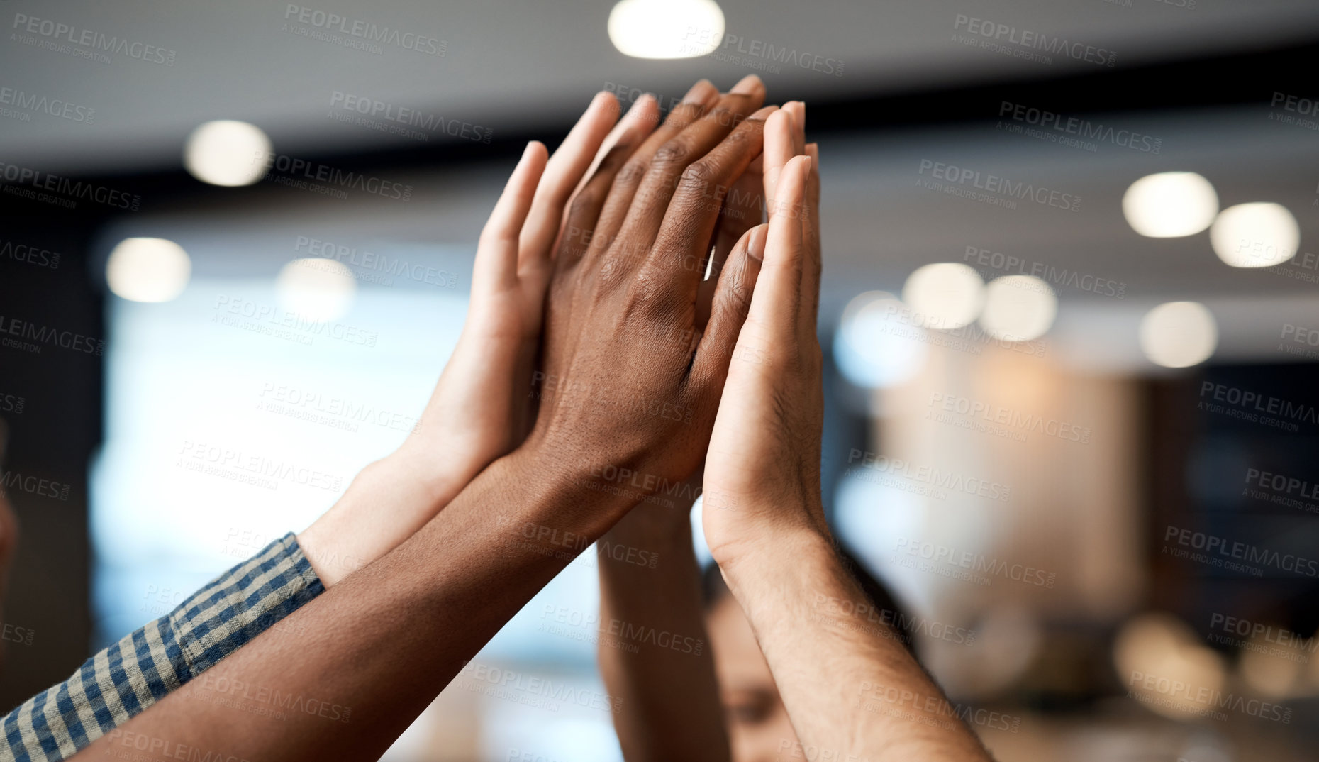 Buy stock photo Shot of a group of businesspeople joining hands in solidarity in a modern office