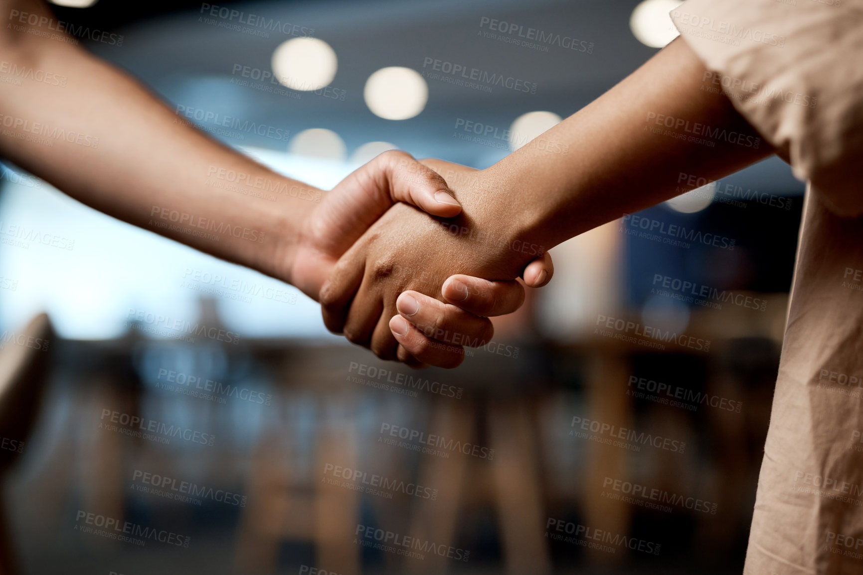 Buy stock photo Shot of two businesspeople shaking hands in a modern office
