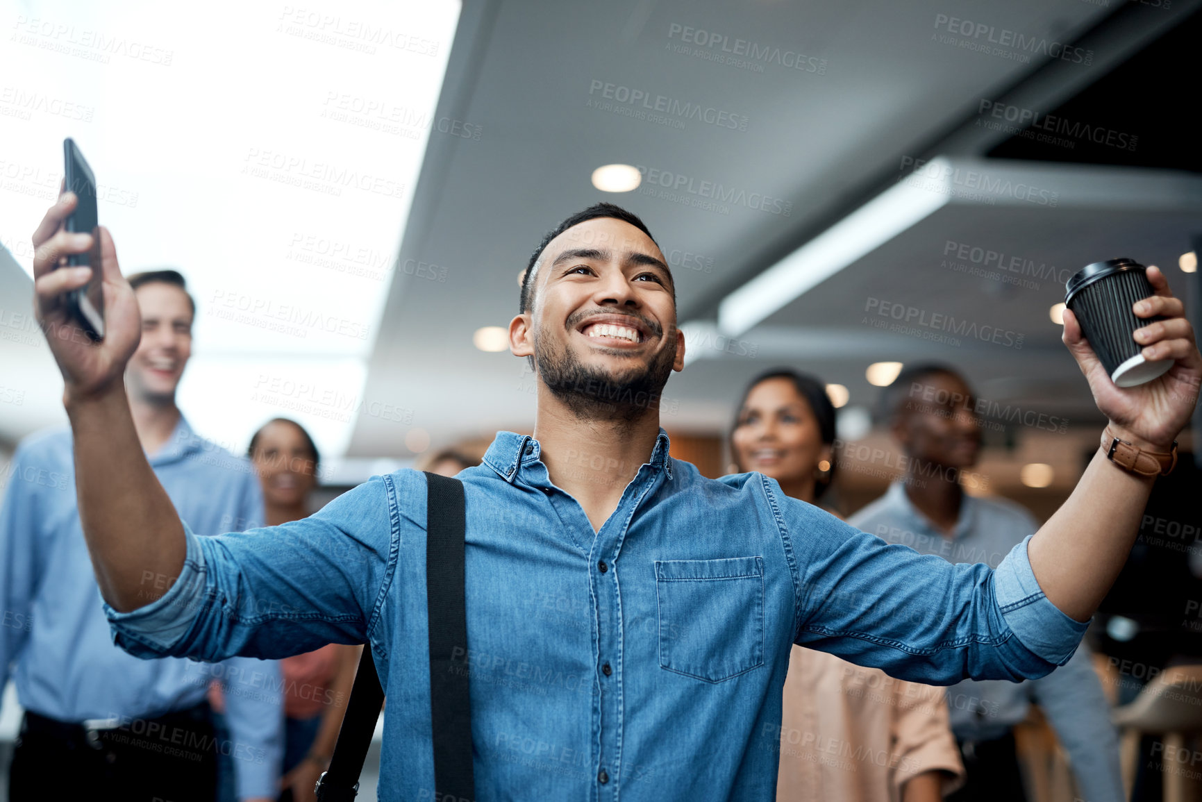 Buy stock photo Shot of a young businessman celebrating during a conference in a modern office