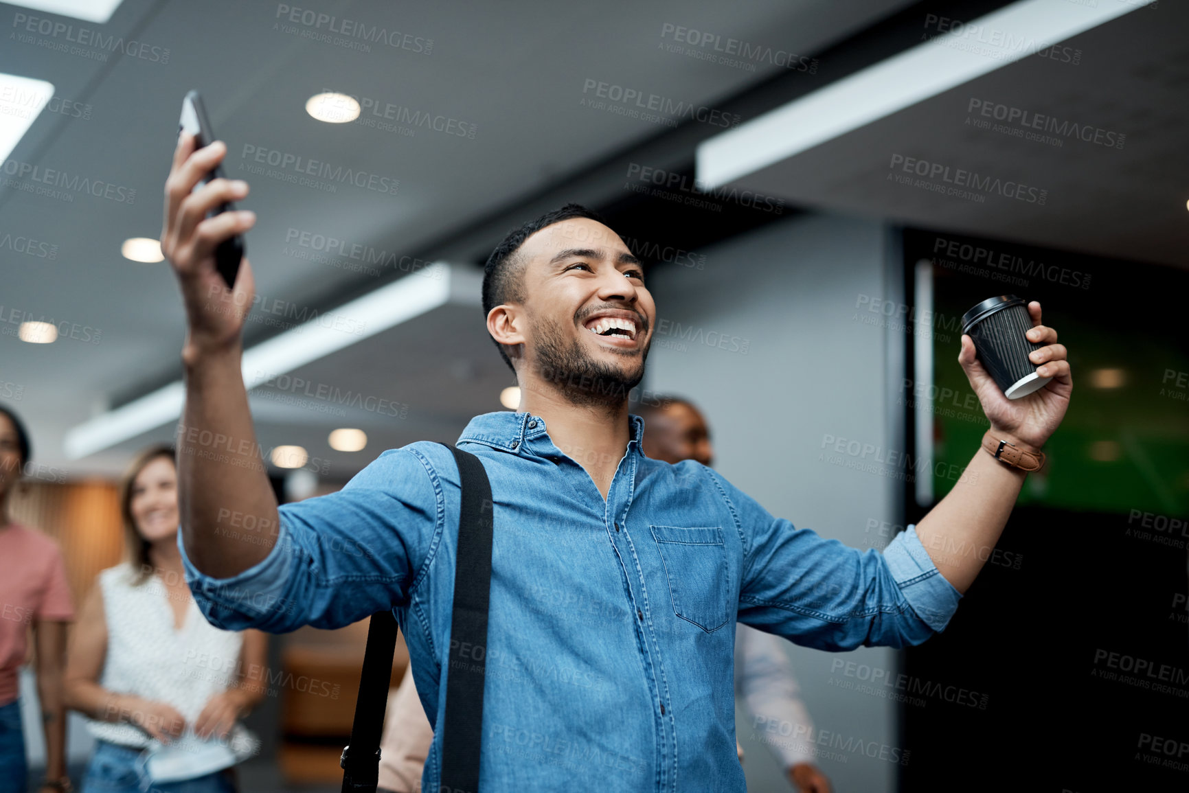 Buy stock photo Shot of a young businessman celebrating during a conference in a modern office