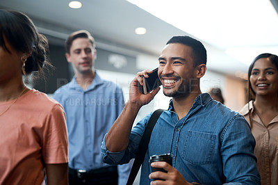 Buy stock photo Shot of a young businessman using a smartphone during a conference