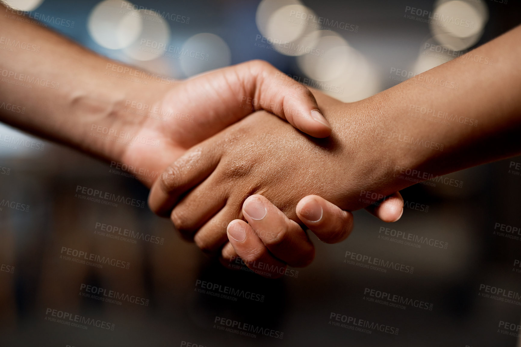 Buy stock photo Shot of two businesspeople shaking hands in a modern office