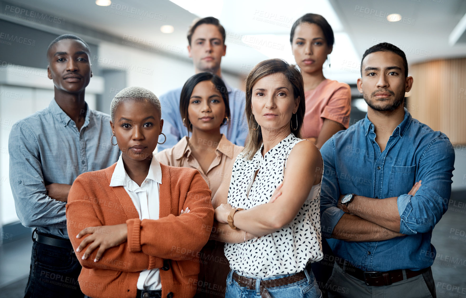 Buy stock photo Portrait of a group of confident young businesspeople working together in a modern office