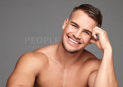 Buy stock photo Studio shot of a handsome young man posing against a grey background