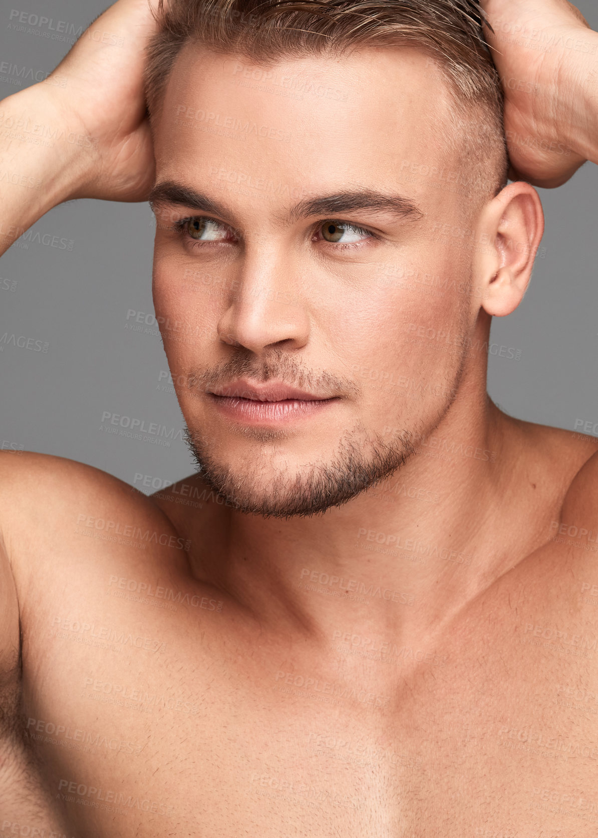 Buy stock photo Studio shot of a handsome young man posing against a grey background