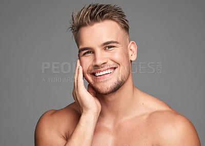 Buy stock photo Studio shot of a handsome young man posing against a grey background