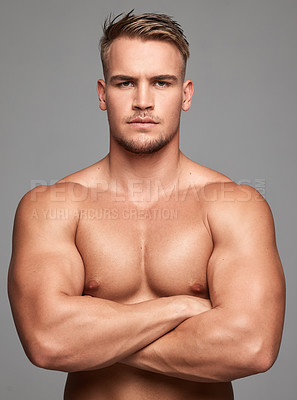 Buy stock photo Studio shot of a handsome young man posing against a grey background