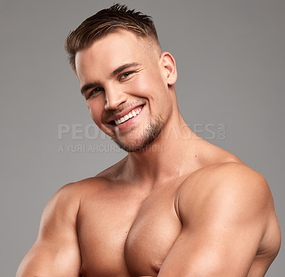 Buy stock photo Studio shot of a handsome young man posing against a grey background