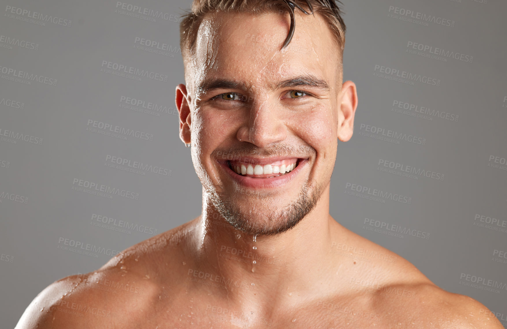 Buy stock photo Studio shot of a handsome young man washing his face against a grey background