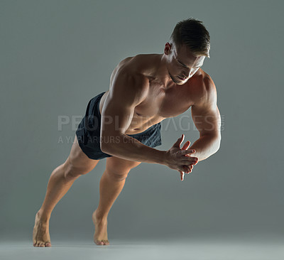 Buy stock photo Shot of a young athlete doing push-ups against a studio background