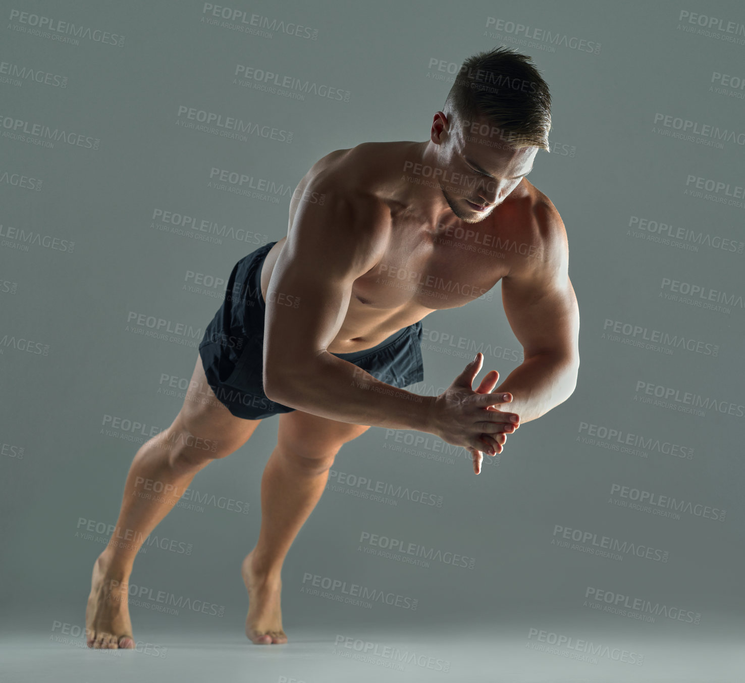 Buy stock photo Shot of a young athlete doing push-ups against a studio background