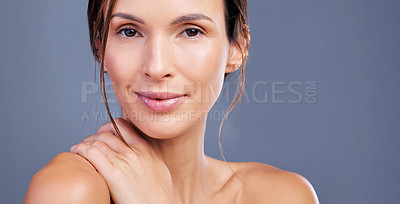 Buy stock photo Shot of a young woman admiring her skin against a studio background