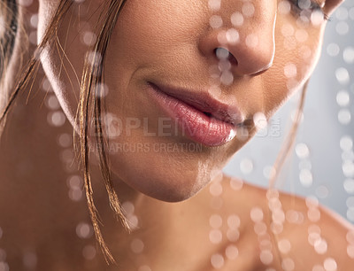 Buy stock photo Closeup shot of an unrecognisable woman taking a shower against a grey background