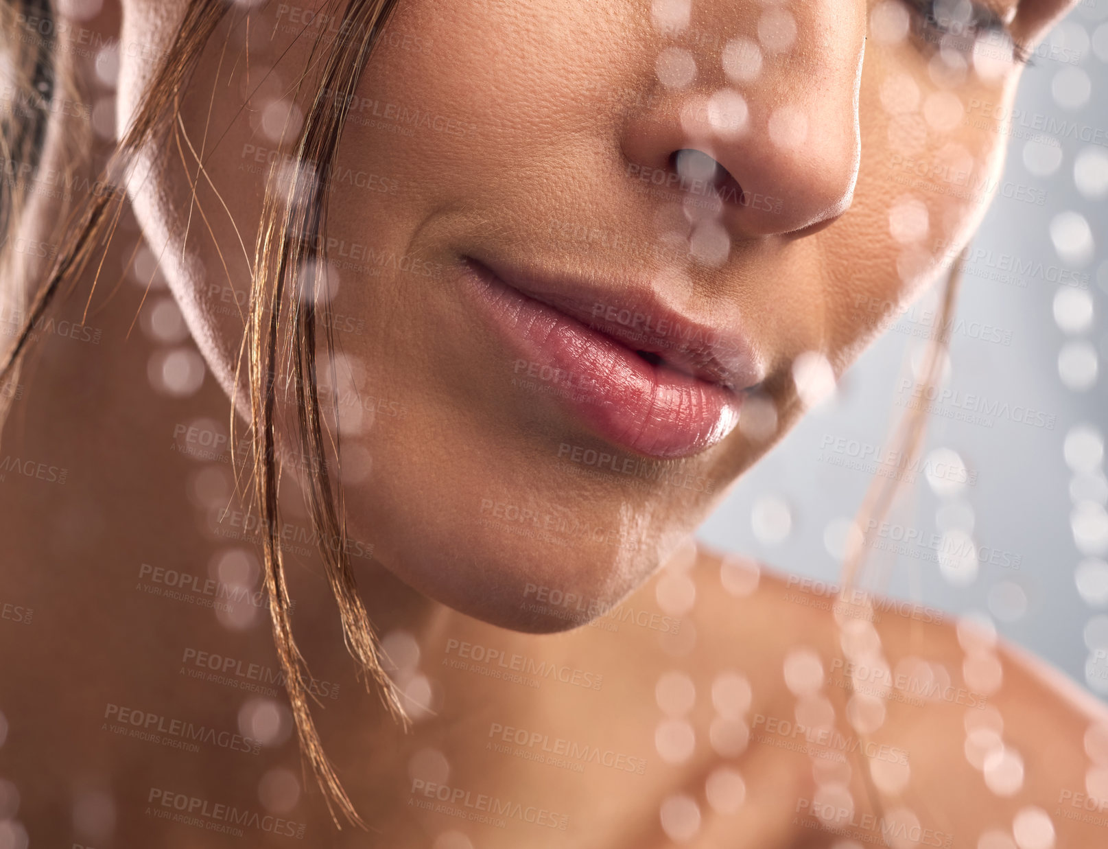 Buy stock photo Closeup shot of an unrecognisable woman taking a shower against a grey background