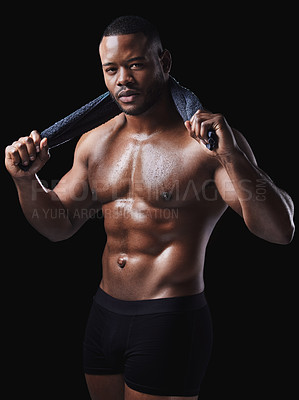 Buy stock photo Studio portrait of a sweaty young man posing against a black background
