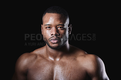 Buy stock photo Studio portrait of a sweaty young man posing against a black background