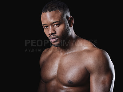 Buy stock photo Studio portrait of a fit young man posing against a black background