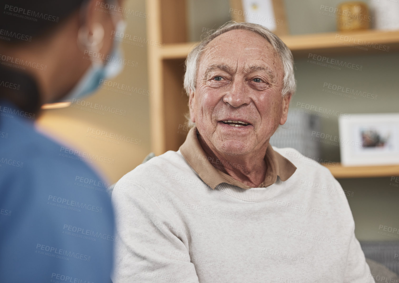 Buy stock photo Nurse, senior man and talk in house for help, support or medical rehabilitation. Retirement, caregiver and elderly patient in conversation in living room for healthcare, check up or wellness in home