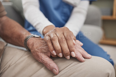 Buy stock photo Shot of an unrecognizable nurse holding a patient's hand during a checkup at home