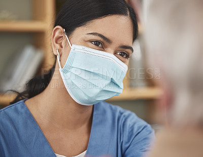 Buy stock photo Shot of a young female nurse having a checkup with a patient at home