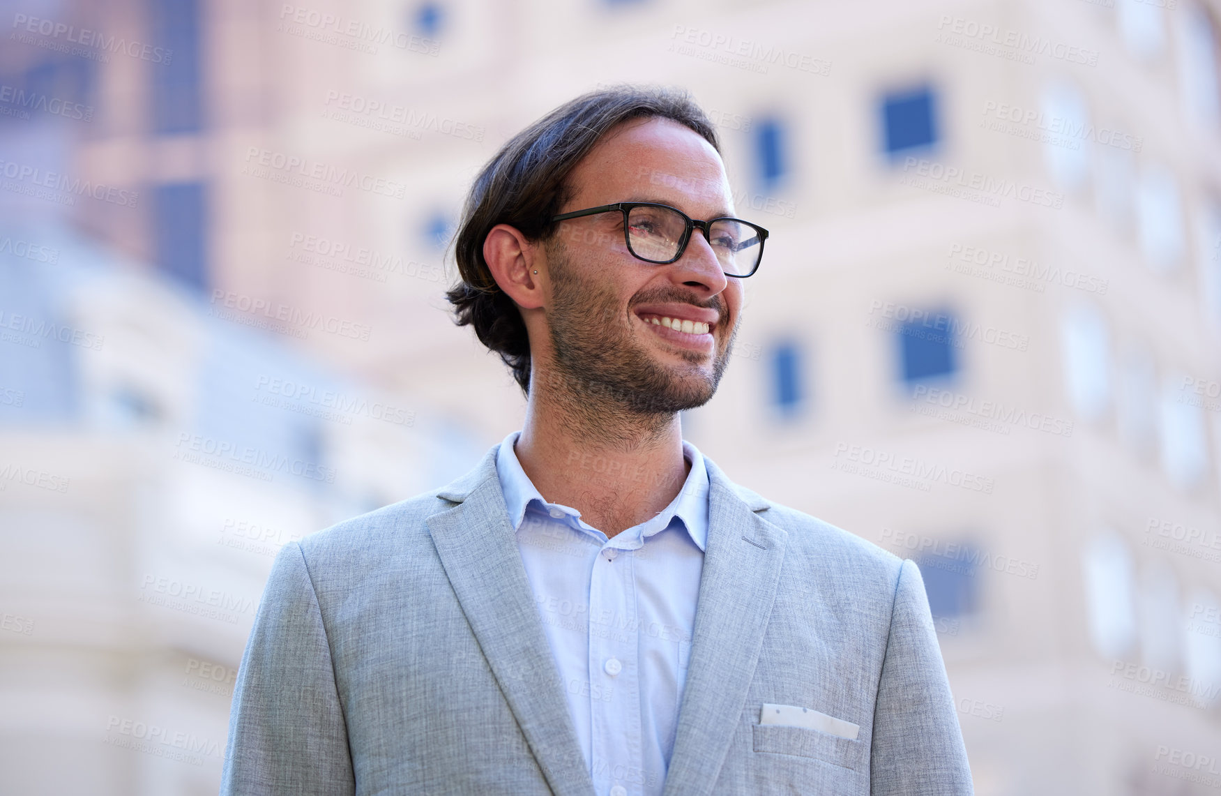 Buy stock photo Shot of a young businessman looking thoughtful while out in the city