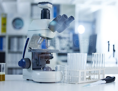 Buy stock photo Shot of a microscope and goggles on a table in a laboratory