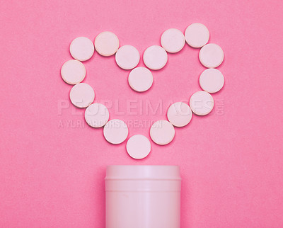 Buy stock photo Studio shot of pills forming a heart against a pink background